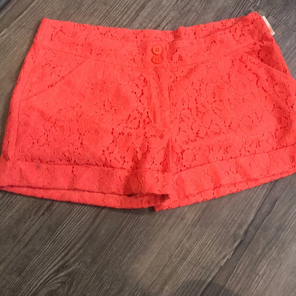 Chino style shorts with lace overlay.